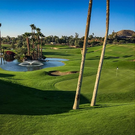 elevated view of green with flagstick and a water feature